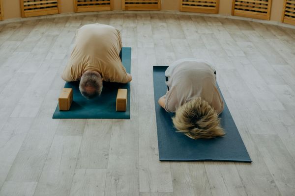 Group of teenagers practicing yoga together in a studio.